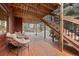 Covered deck with outdoor seating, stairs, and backyard views for relaxation and entertaining at 9239 Black Mountain Dr, Conifer, CO 80433