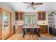 Cozy dining area with a wooden table, stylish chairs, and access to the outdoor deck at 9239 Black Mountain Dr, Conifer, CO 80433