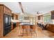 Bright kitchen with an island and stainless steel appliances, complemented by stylish seating and a cozy breakfast nook with natural light at 9239 Black Mountain Dr, Conifer, CO 80433