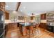 Spacious kitchen featuring a large center island, wood cabinetry, and stainless steel appliances at 9239 Black Mountain Dr, Conifer, CO 80433