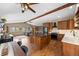 Open concept kitchen featuring an island, stainless steel appliances, custom cabinetry, and hardwood floors, creating an inviting space at 9239 Black Mountain Dr, Conifer, CO 80433