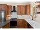 Well-appointed kitchen featuring updated appliances, white countertops, and sleek fixtures at 9239 Black Mountain Dr, Conifer, CO 80433