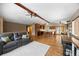 An open-concept space is anchored by a view of the kitchen, which features an island with seating, and the living room beyond at 9239 Black Mountain Dr, Conifer, CO 80433
