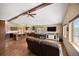 Inviting living area featuring vaulted ceilings, hardwood floors, and generous natural light throughout the space at 9239 Black Mountain Dr, Conifer, CO 80433