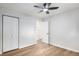 Bright, empty bedroom showing closet, doorway, and light wood floors at 380 S Xanadu St, Aurora, CO 80012