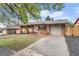 Attractive brick home with a spacious driveway and well-manicured front yard at 380 S Xanadu St, Aurora, CO 80012