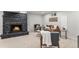 Inviting living room with stone fireplace, cozy seating, and neutral carpeting at 380 S Xanadu St, Aurora, CO 80012