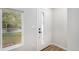 Modern white front door with glass accents and neutral-toned interior at 380 S Xanadu St, Aurora, CO 80012