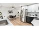 Well-lit kitchen features stainless steel appliances, modern cabinetry, and adjacent dining area at 380 S Xanadu St, Aurora, CO 80012