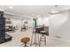 Large living room with wet bar area, neutral carpet, and stylish furniture at 380 S Xanadu St, Aurora, CO 80012