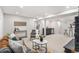 Open living room with a wet bar, neutral carpet and stylish furniture at 380 S Xanadu St, Aurora, CO 80012