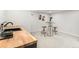 Well-lit wet bar area featuring a wooden countertop, stylish stools, and modern decor at 380 S Xanadu St, Aurora, CO 80012