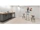 Cozy area featuring a wet bar with ample counter space, sleek cabinetry, and modern accents at 380 S Xanadu St, Aurora, CO 80012