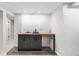 Basement wet bar area boasts sleek cabinetry, wooden countertops, and convenient access to the living space at 380 S Xanadu St, Aurora, CO 80012