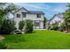 Lush backyard featuring a well-manicured lawn, privacy landscaping, and a charming two-story home exterior at 3775 Balderas St, Brighton, CO 80601