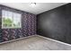 Unique bedroom with floral accent wall and plush carpet throughout at 3775 Balderas St, Brighton, CO 80601