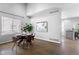 Open concept dining room features a wooden dining table and chairs with a view to the kitchen at 3775 Balderas St, Brighton, CO 80601