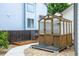 Backyard with wooden greenhouse and adjacent garden beds at 3775 Balderas St, Brighton, CO 80601