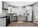 Modern kitchen with stainless steel appliances, mosaic backsplash, and granite countertops at 3775 Balderas St, Brighton, CO 80601