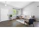 Bright living room features modern design, updated furniture, and a large window for ample natural light at 3775 Balderas St, Brighton, CO 80601