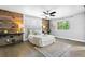 Spacious main bedroom with wood accent wall and ceiling fan offers a serene and inviting atmosphere at 3775 Balderas St, Brighton, CO 80601