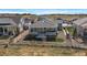 Backyard view featuring a landscaped fenced yard, patio and exterior of home with solar panels at 5611 Saddle Skirt St, Parker, CO 80134