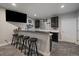 Finished basement wet bar area featuring seating, a television, storage and ample counterspace at 5611 Saddle Skirt St, Parker, CO 80134