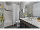 This bathroom boasts a shower and tub combo, a modern vanity, and updated fixtures at 5611 Saddle Skirt St, Parker, CO 80134