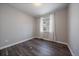 This bedroom features dark wood laminate flooring and a single window providing natural light at 5611 Saddle Skirt St, Parker, CO 80134