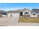 Beautiful single-Gathering home featuring a well-manicured lawn, three-car garage and stone facade at 5611 Saddle Skirt St, Parker, CO 80134