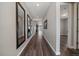 Inviting home hallway with wood floors, decorative mirrors, and views of the living area at 5611 Saddle Skirt St, Parker, CO 80134