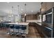 Modern kitchen boasts stainless appliances, a large island with pendant lighting and seating for four at 5611 Saddle Skirt St, Parker, CO 80134
