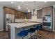 Contemporary kitchen with a large island, pendant lights, stainless steel appliances, and cabinetry at 5611 Saddle Skirt St, Parker, CO 80134