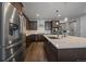 Gourmet kitchen featuring an island, stainless steel appliances, ample counter space and a center island sink at 5611 Saddle Skirt St, Parker, CO 80134