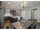 Modern kitchen with a center island, stainless appliances, and eat-in kitchen dining area at 5611 Saddle Skirt St, Parker, CO 80134