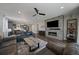 Open-concept living room flows into the kitchen, featuring a fireplace, mounted tv, and ample seating at 5611 Saddle Skirt St, Parker, CO 80134
