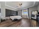 A spacious main bedroom features a tray ceiling, stylish furniture, and ample natural light at 5611 Saddle Skirt St, Parker, CO 80134