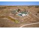 Aerial view of a community clubhouse with a green roof and outdoor pool and pond in a beautiful setting at 5611 Saddle Skirt St, Parker, CO 80134
