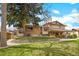 Expansive backyard view showcasing the patio, lush lawn, and the home's exterior at 2160 S Flower St, Lakewood, CO 80227
