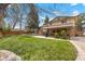 Green backyard featuring a well-maintained lawn, patio area, and mature trees providing shade and privacy at 2160 S Flower St, Lakewood, CO 80227