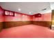 Retro basement showcasing colorful wallpaper, wood paneling, and classic red carpeting at 2160 S Flower St, Lakewood, CO 80227