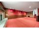 Finished basement boasts a vintage brick fireplace, retro wallpaper, and classic built-in shelving at 2160 S Flower St, Lakewood, CO 80227