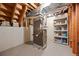 Unfinished basement area showing the home's utility systems and storage solutions at 2160 S Flower St, Lakewood, CO 80227
