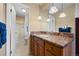 Bright bathroom with granite vanity and stylish light pendants above mirror at 2160 S Flower St, Lakewood, CO 80227