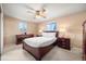 Carpeted bedroom with ceiling fan, windows and rich-toned wooden furniture at 2160 S Flower St, Lakewood, CO 80227