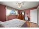 This bedroom features wood floors, a plush bed, a window, and wood furnishings at 2160 S Flower St, Lakewood, CO 80227