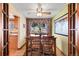 Traditional dining room features hardwood floors, a ceiling fan, and picture window at 2160 S Flower St, Lakewood, CO 80227