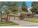 Well-maintained two-story home with a two-car garage, inviting front porch, and established landscaping at 2160 S Flower St, Lakewood, CO 80227