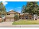 Charming two-story home with a well-manicured lawn, brick accents, and a two-car garage, perfect for Gathering living at 2160 S Flower St, Lakewood, CO 80227