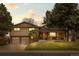 Beautiful front exterior view of the house during the evening, enhanced by warm lighting and a manicured lawn at 2160 S Flower St, Lakewood, CO 80227